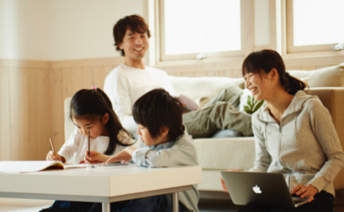 Two children and parents studying